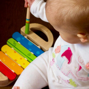 Baby with a Multicolored Xylophone - Image